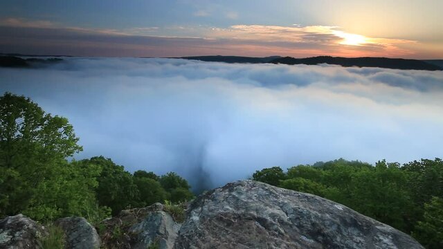 early morning spring sunrise on a sea of clouds covering the New River Gorge National Park in West Virginia.