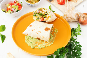 Three sauce burrito. Yellow plate, white background.
