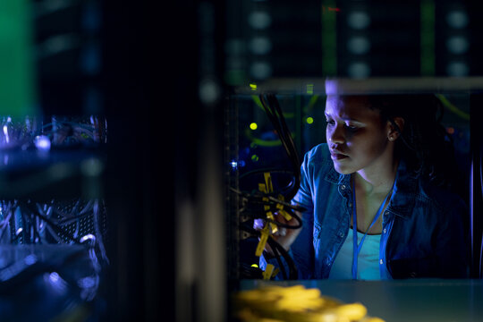 African american female computer technician working in server room