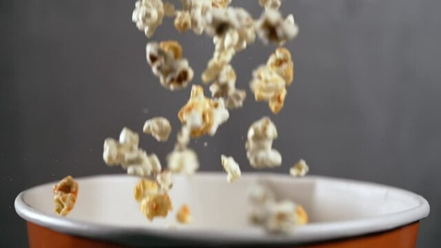 Motion blur image of popcorn falling into a tub