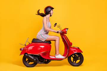 Fototapeta na wymiar Full length body size side photo woman riding bike wearing dress helmet smiling happy isolated bright yellow color background