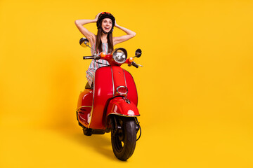 Fototapeta na wymiar Full length body size photo girl riding motorbike looking copyspace amazed in helmet isolated vivid yellow color background