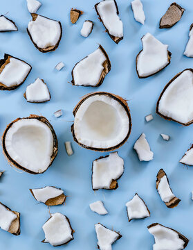 Broken coconut shells on a blue background