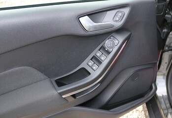 Fototapeta na wymiar Car door handle with adjustment knobs.