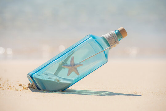 Blue glass bottle still life on a tropical beach paradise