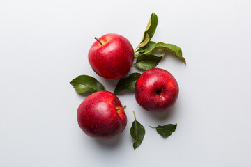 Many red apples on colored background, top view. Autumn pattern with fresh apple above view with copy space for design or text