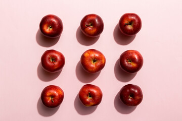 Many red apples on colored background, top view. Autumn pattern with fresh apple above view