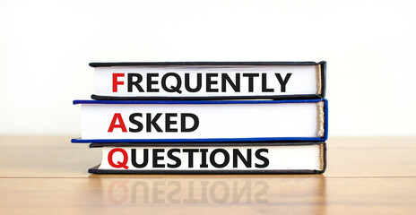 FAQ frequently asked questions symbol. Concept words 'FAQ frequently asked questions' on books on a beautiful wooden table, white background. Business and FAQ frequently asked questions concept.