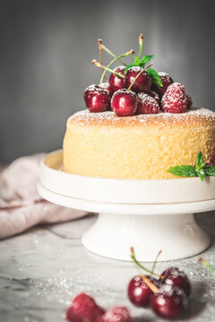 A homemade Japanesse souffle cheesecake served with fresh cherries