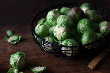 Raw brussel sprouts on a wooden background.
