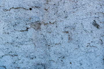 Old brick shining through a rough plastered surface