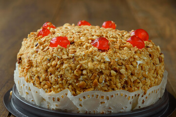 Delicious cake with peanut and cherry ontop