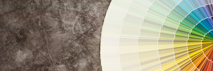 A painter is choosing a paint shade for the interior of the house's walls. with interior - obrazy, fototapety, plakaty