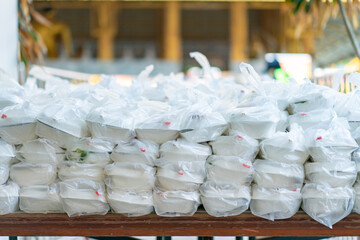 Asian foam food packages are prepare in plastic bag for donation to people.