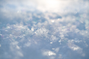 Blurred snowy abstract background, with fluffy snow, snowflakes and bokeh. Blurred snowy abstract...