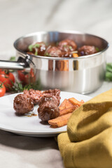 Stewed meatballs in cheese sauce