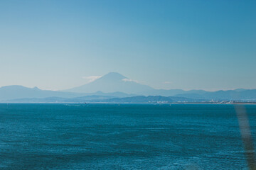 Romantic seascape photo of Japan beach in kannagawa, Enoshima area during golden time and sunset period which be able to see Fuji mountain from here. It's very famous recreational place in summer.