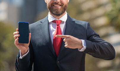bearded businessperson in formalwear pointing finger on phone outside the office, cyber monday