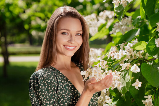 Photo of nice brown haired happy cheerful woman smile spring flowers trees bloom outdoors outside park street