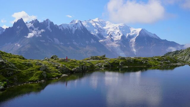 Athlete trail running at Lac De Cheserys, with the Mont Blanc in the background