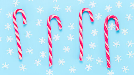 Christmas background with candy canes and snowflakes. Xmas, winter and New Year concept