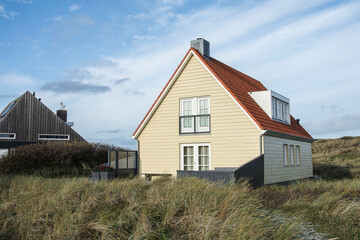 Vacation home in the dunes of the Wadden island Vlieland on a sunny day  in autumn