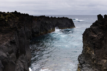Fototapeta na wymiar Volcanic lava formations on the coast at Ferraria, Sao Miguel island, Azores