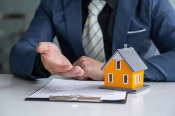 The real estate agent is explaining the contract to rent or buy, inspect the sample home and Business contract, lease, purchase, mortgage, loan or home insurance documents