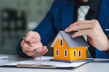 The real estate agent is explaining the contract to rent or buy, inspect the sample home and Business contract, lease, purchase, mortgage, loan or home insurance documents