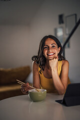 Adult woman, taking a picture, during dinner.