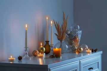 christmas decorations with burning candles in white room