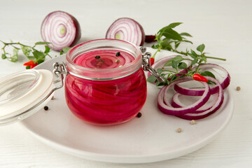 pickled red onions in a glass pot