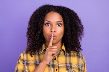 Photo of young silent afro american woman hold finger face mouth shut up isolated on violet color...