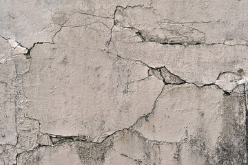 dangerous structure a defective cracked concrete wall,  from weathering, moisture.