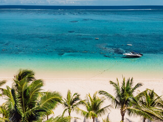 Luxury beach in Mauritius. Sandy beach with coconut palms and tropical sea. Aerial view