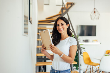 Adult woman, happily decorating her home.