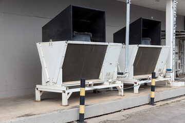 Air conditioner compressor installed in old building. Cooling towers in data center building. ...