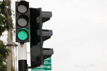 Green traffic light up in city. Green color on the traffic light.
