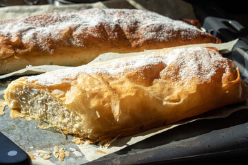 Original Hungarian homemade poppy seed and cottage cheese strudel on an oven tray