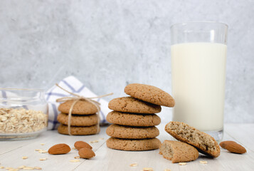 Oatmeal cookies and a glass of milk on a light background