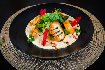 Salad with vegetables and bread on black background