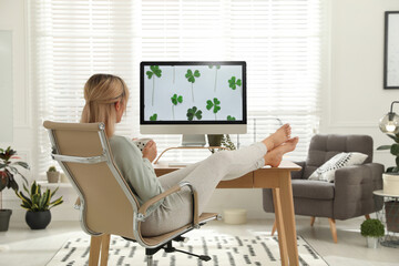 Woman with cup of tea at table in light room. Home office