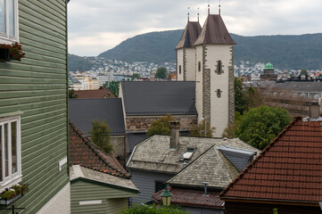 Towers of Saint Mary's Church, side view. Old Norwegian parish church is located in the Bryggen area in central part of city. Bergen, Norway.