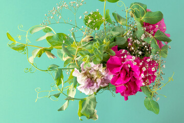 flower arrangement of peas and petunias on mint background