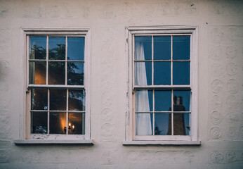 Two double hung windows of a white house in Cambridge England