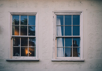 Two double hung windows of a white house in Cambridge England