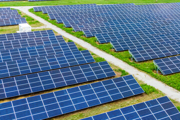 Solar energy panel photovoltaic cell. alternative energy  on a green field. View from above. lots of solar panels for green energy