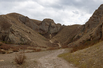 The path to the small cave in Tamgaly Tas tract. Tamgaly became a UNESCO World Heritage Site in 2004. Republic of Kazakhstan, Almaty Region.