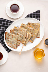 Thin crepes with poppy seeds.
