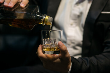 Businessmen in suits drinking whiskey